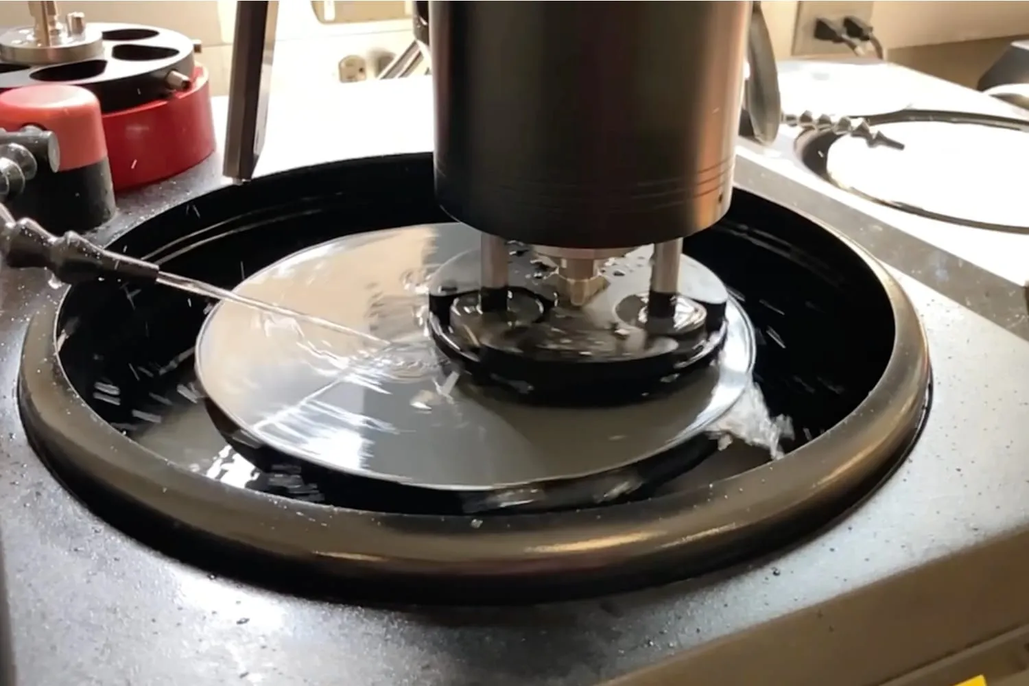 Allied MetPrep 3x grinder/polisher using its PH-3 power head to prepare mounted specimens on a rotating platen.